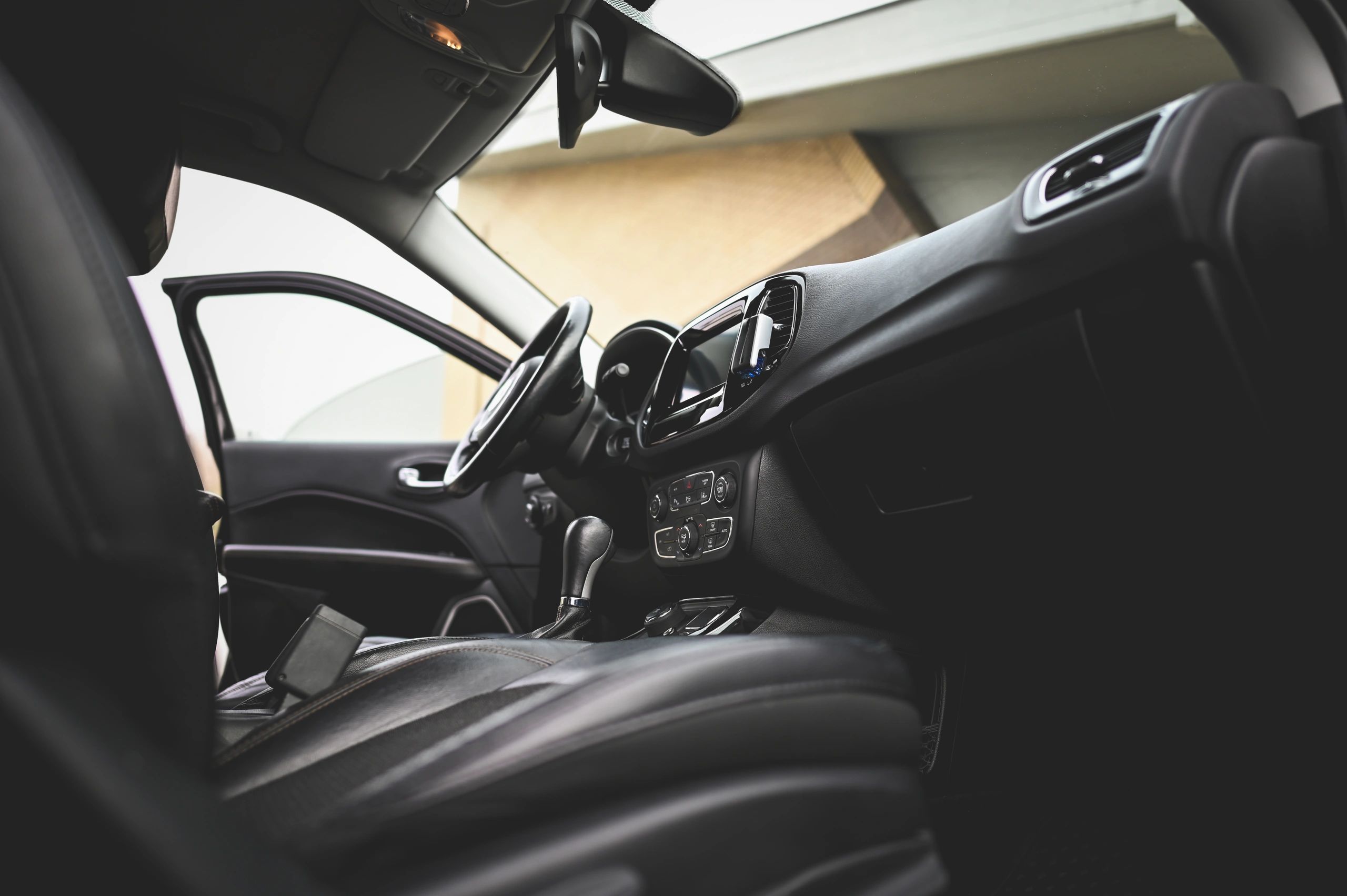 Modern car interior with clean leather seats and dashboard